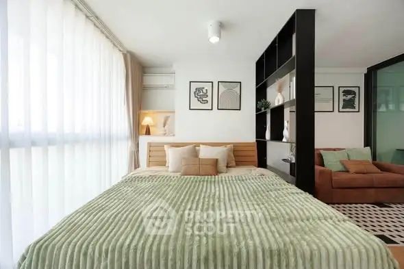 Modern bedroom with stylish decor and natural light in a contemporary apartment.