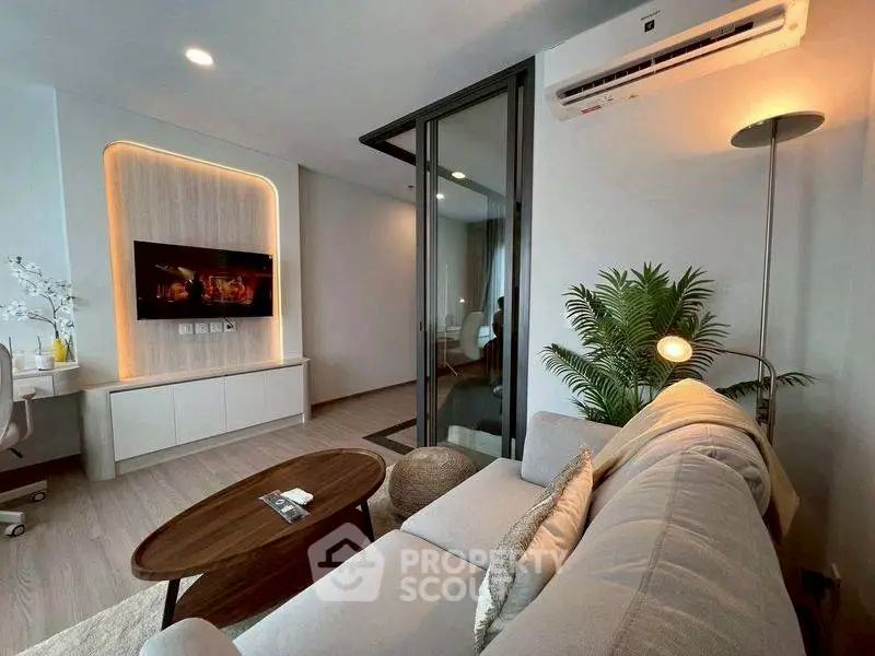 Modern living room with sleek design, cozy sofa, and stylish decor in a contemporary apartment.