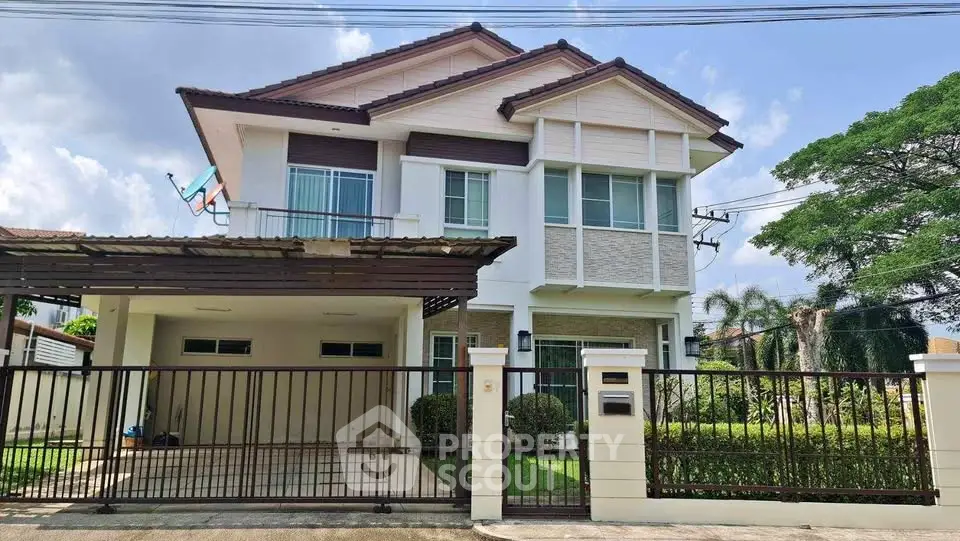 Modern two-story house with spacious driveway and lush greenery