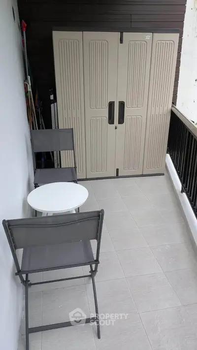 Spacious balcony with seating and storage, perfect for relaxation and outdoor enjoyment.