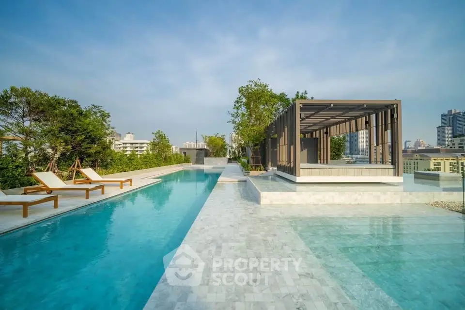 Luxurious rooftop pool with modern pergola and city skyline view, perfect for relaxation and entertainment.