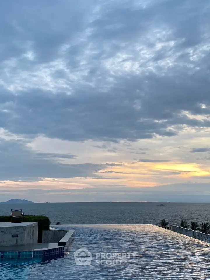 Luxurious infinity pool with stunning ocean view at sunset