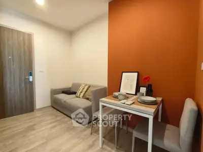 Cozy living room with modern decor and dining area in a stylish apartment.
