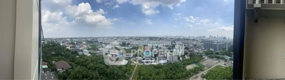 Stunning panoramic cityscape view from high-rise building window, showcasing urban skyline and lush greenery.