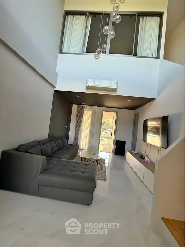 Spacious modern living room with high ceiling and stylish decor