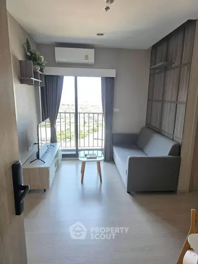 Modern living room with balcony view, featuring sleek furniture and natural light.