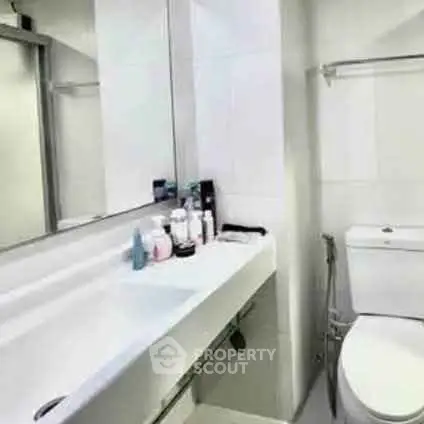 Modern bathroom with sleek fixtures and ample counter space.