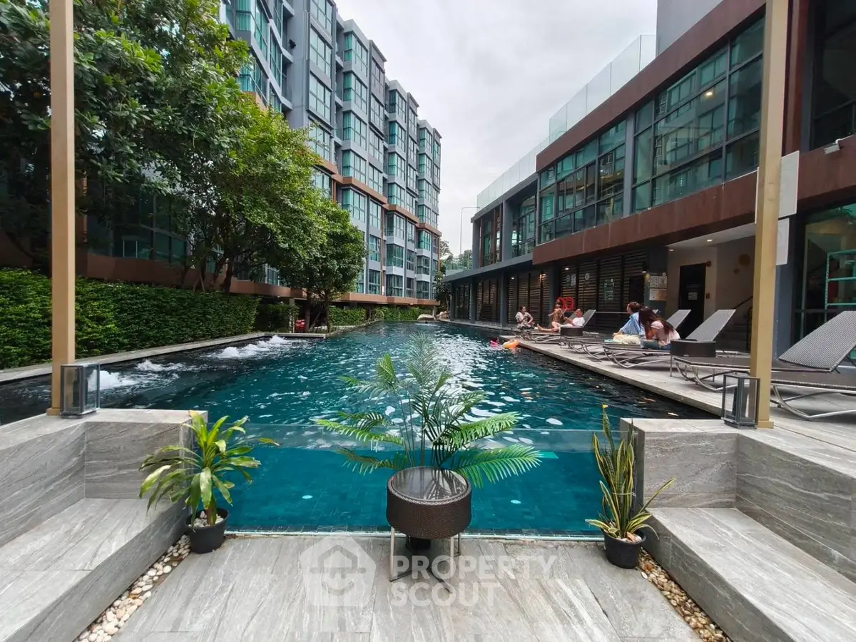 Luxurious apartment complex with stunning pool and modern architecture, perfect for relaxation and leisure.