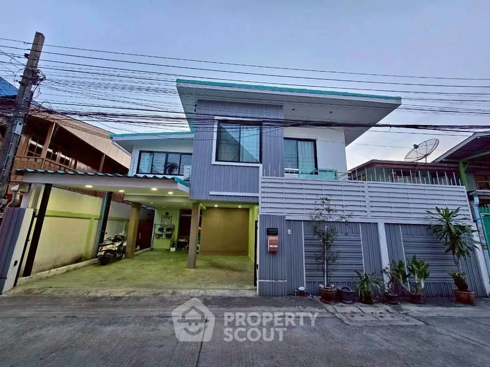Modern two-story house with spacious garage and contemporary design in a suburban neighborhood.
