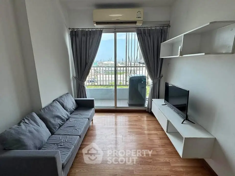 Modern living room with balcony view, featuring sleek furniture and natural light.