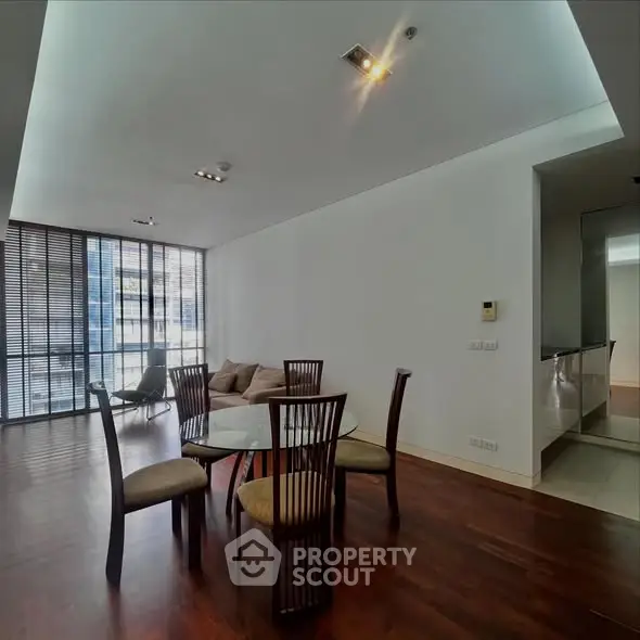 Spacious modern living room with elegant dining area and large windows