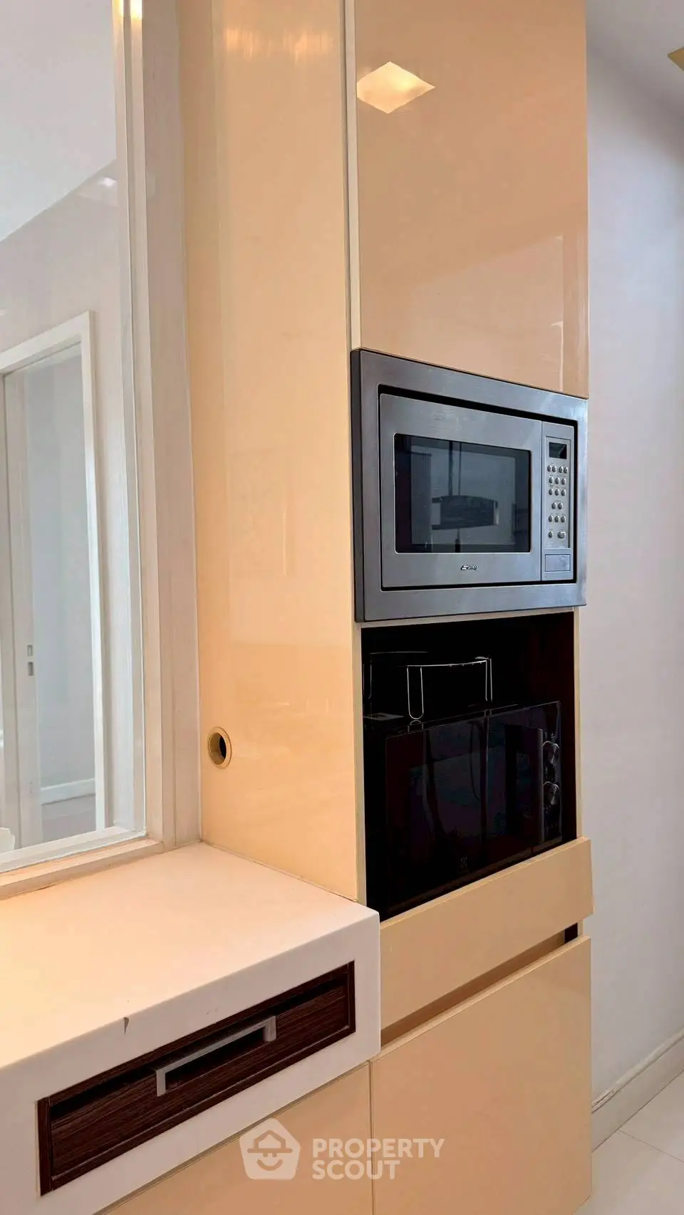 Modern kitchen with built-in microwave and sleek cabinetry