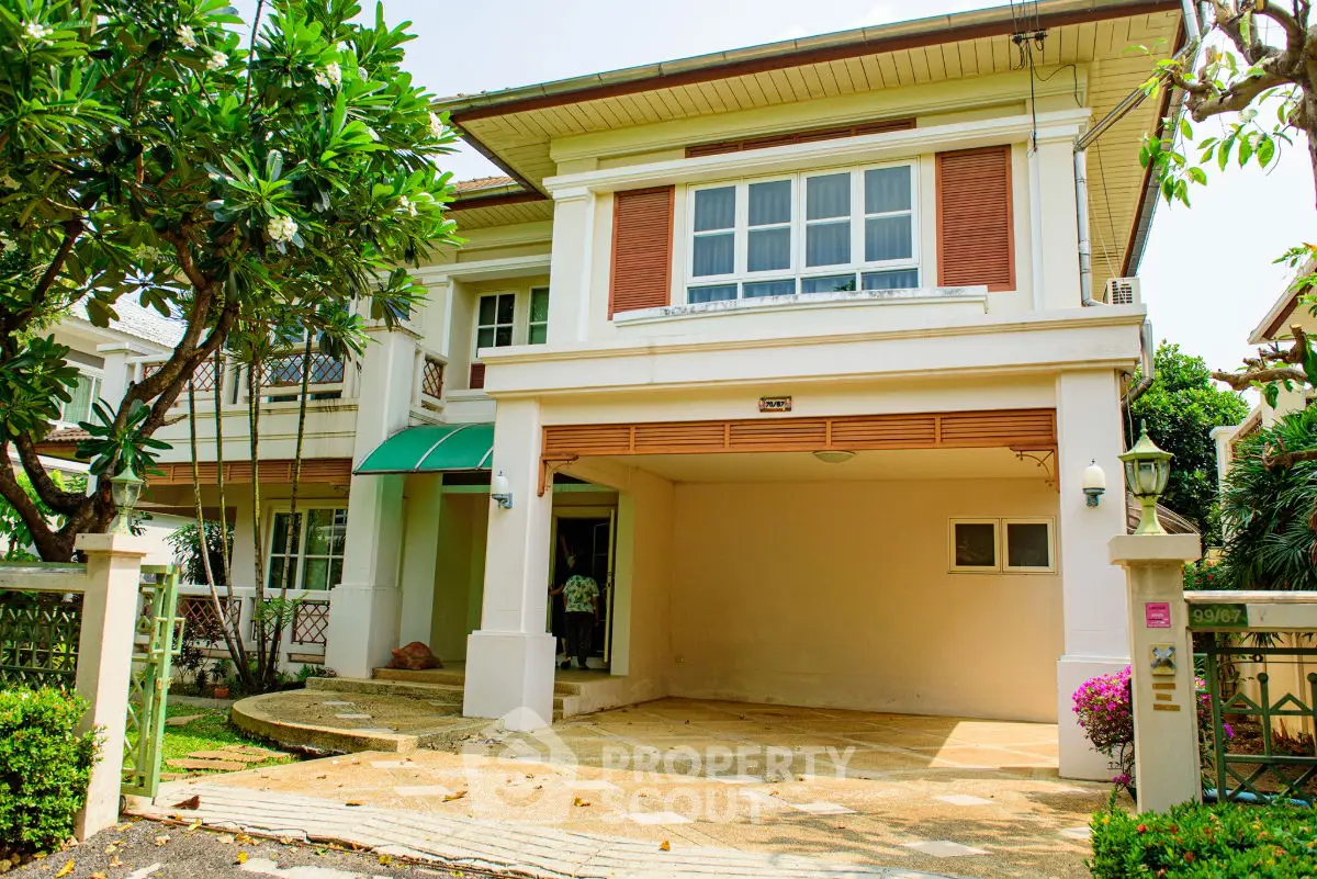 Charming two-story house with lush garden and spacious driveway in serene neighborhood.