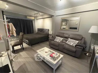 Modern studio apartment with stylish gray decor and cozy furnishings.