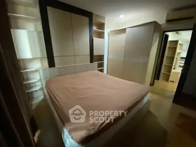 Cozy bedroom with modern built-in storage and warm lighting