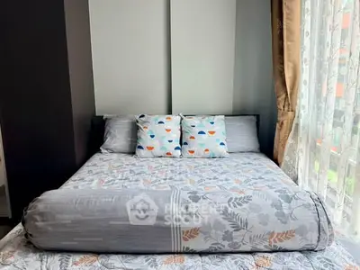Cozy bedroom with stylish bedding and natural light from large window