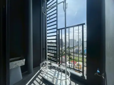 Modern balcony with city view and drying rack, perfect for urban living.