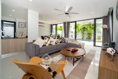 Spacious modern living room with large windows and stylish furniture