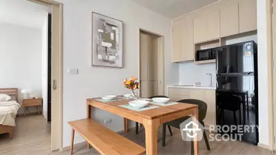 Modern kitchen and dining area with wooden furniture and sleek appliances