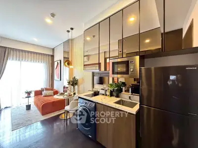 Modern open-layout kitchen with sleek appliances and cozy living area
