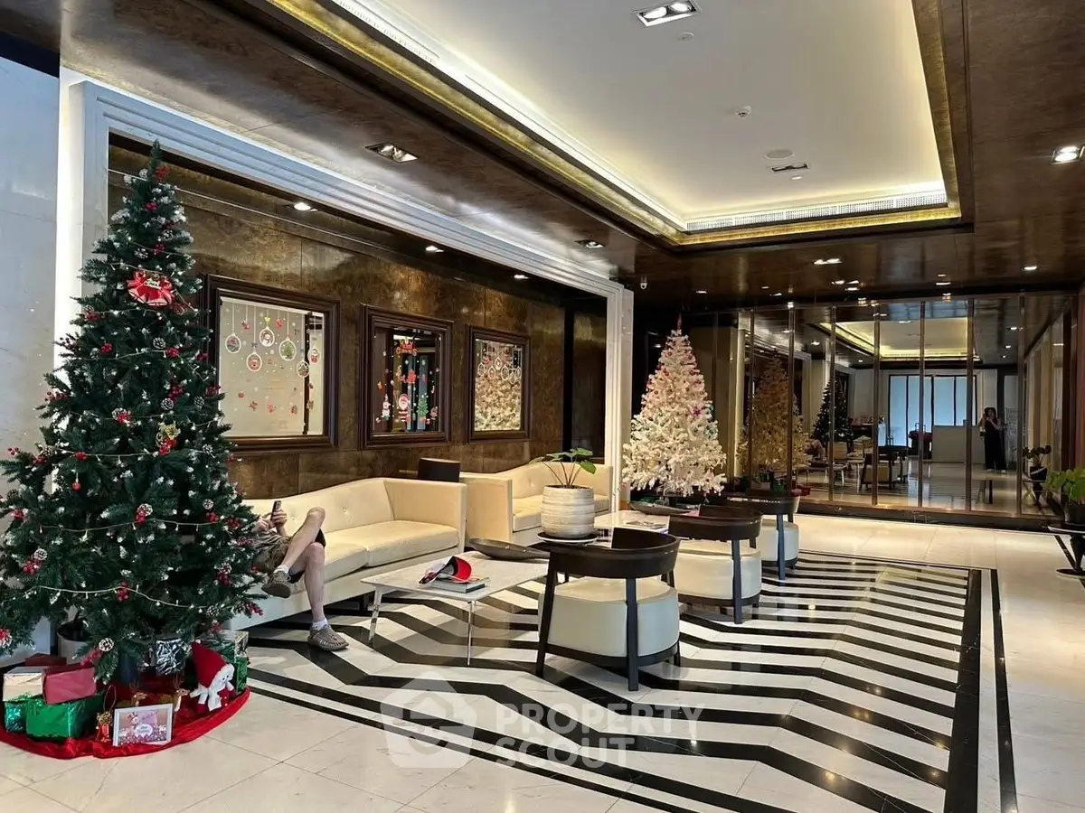 Luxurious building entrance with festive Christmas decor and elegant seating area.
