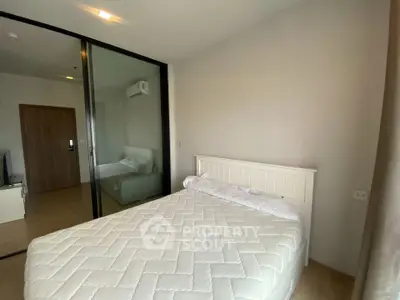 Cozy bedroom with modern design and glass partition in a stylish apartment.