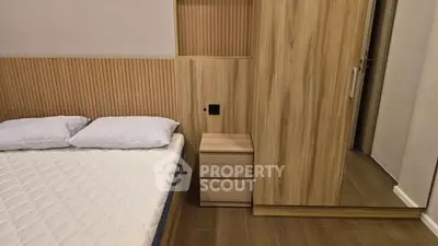 Modern bedroom with wooden wardrobe and cozy bed setup