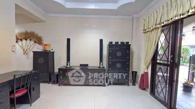 Spacious living room with elegant decor and large windows for natural light.
