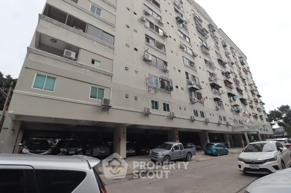 Spacious apartment building with ample parking space in urban setting