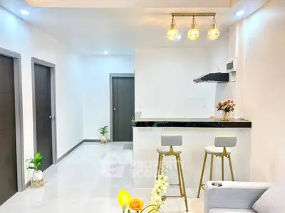 Modern open kitchen with sleek bar stools and elegant lighting