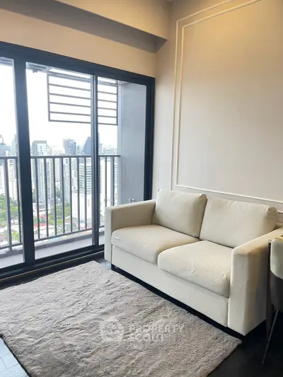 Modern living room with cozy sofa and city view balcony in high-rise apartment.