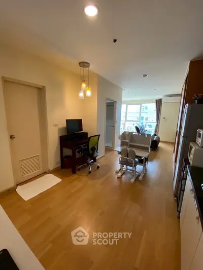Spacious living room with modern furnishings and natural light in a contemporary apartment.