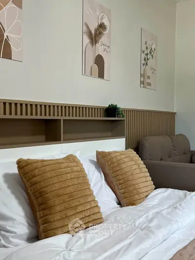 Cozy bedroom with stylish decor and plush pillows, perfect for relaxation.
