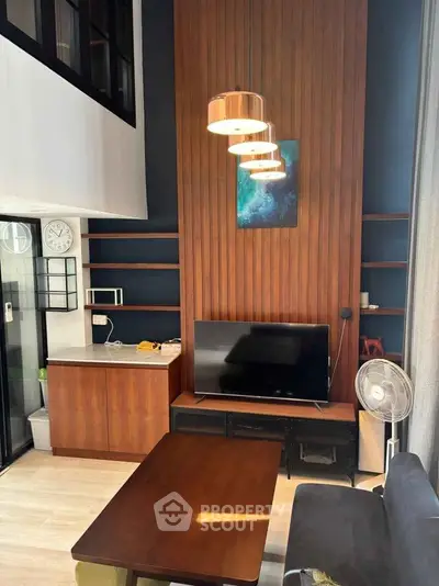 Modern living room with high ceiling, stylish wood paneling, and contemporary furniture.