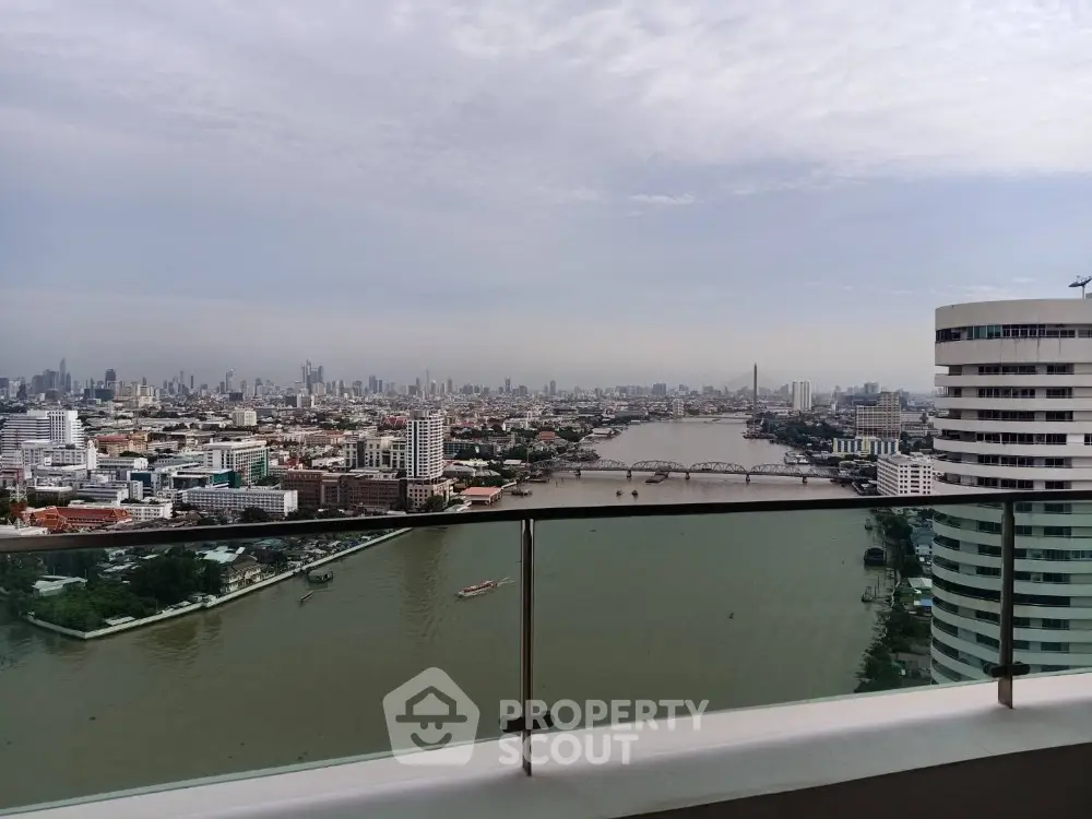 Stunning cityscape view from high-rise balcony overlooking river and skyline