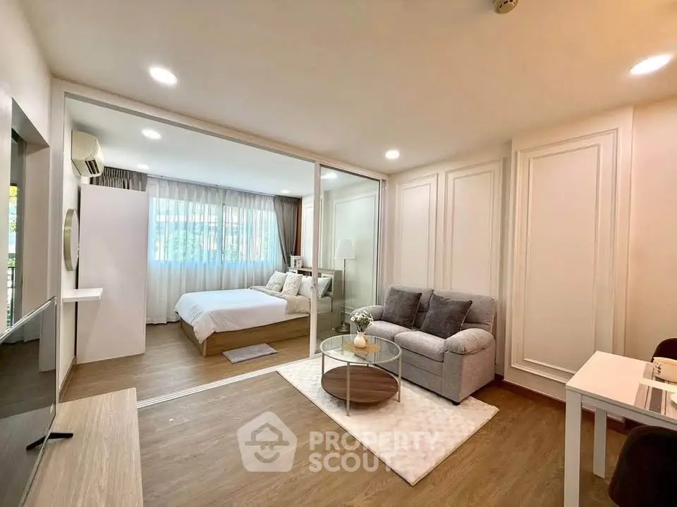 Modern studio apartment with cozy living area and stylish bedroom