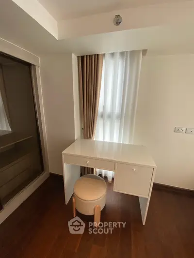 Chic study nook with modern desk and stool, perfect for a home office setup.