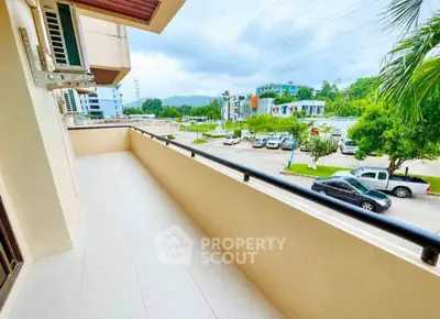 Spacious balcony with scenic view in modern residential area, perfect for relaxation and outdoor enjoyment.