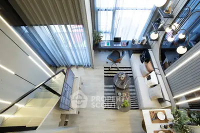 Modern loft-style living room with high ceilings, stylish decor, and large windows for natural light.