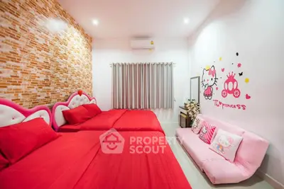 Charming bedroom with vibrant red bedding and playful wall decor