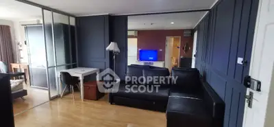 Modern living room with sleek black sofa and stylish decor