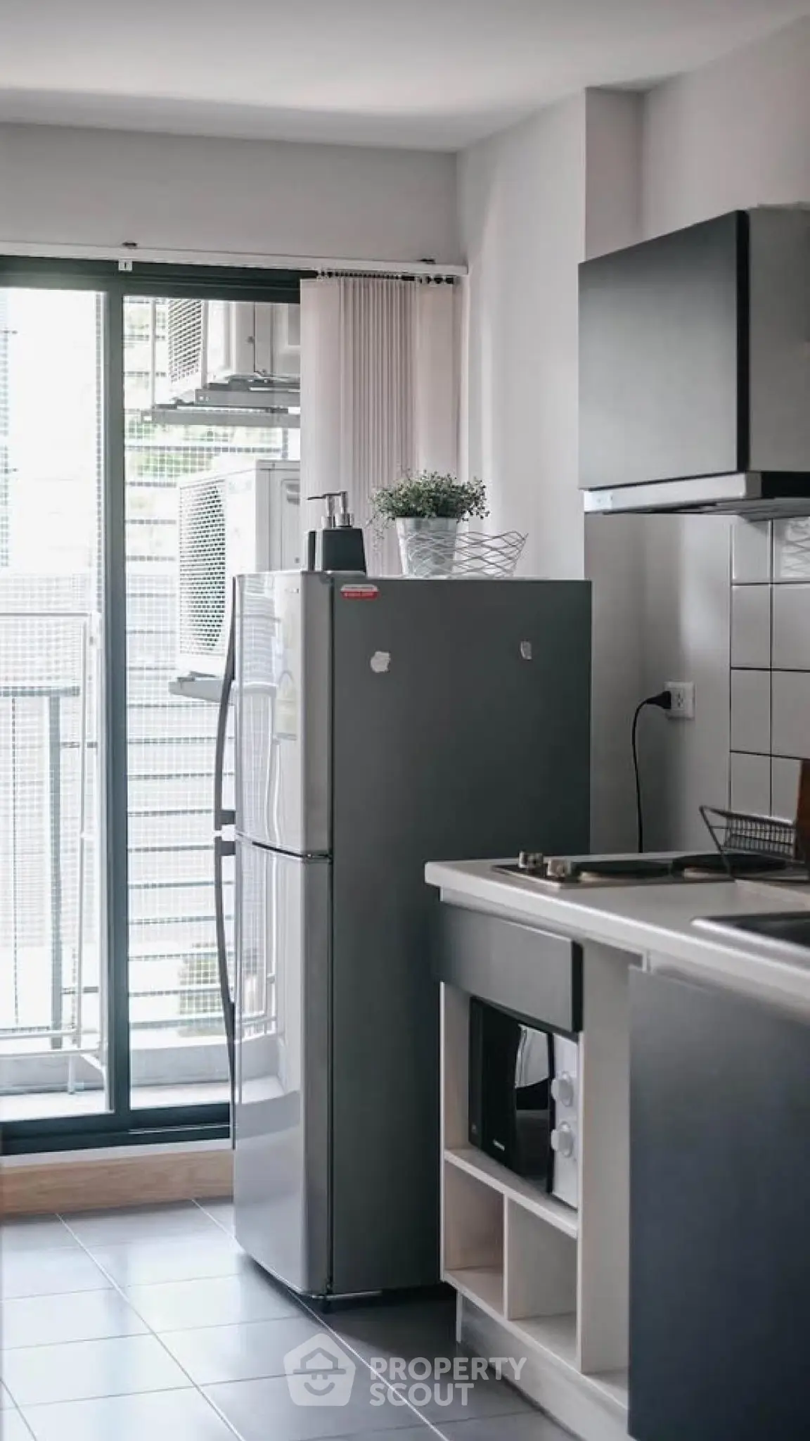 Modern kitchen with sleek appliances and balcony view