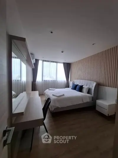 Modern bedroom with stylish decor and natural light