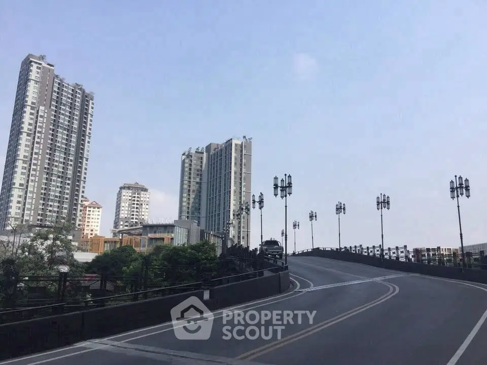 Modern urban skyline with high-rise buildings and a clear blue sky, showcasing city living.