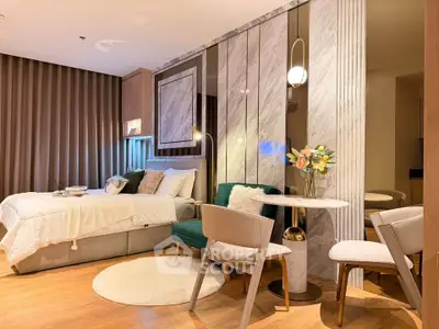 Luxurious modern bedroom with elegant decor and cozy seating area
