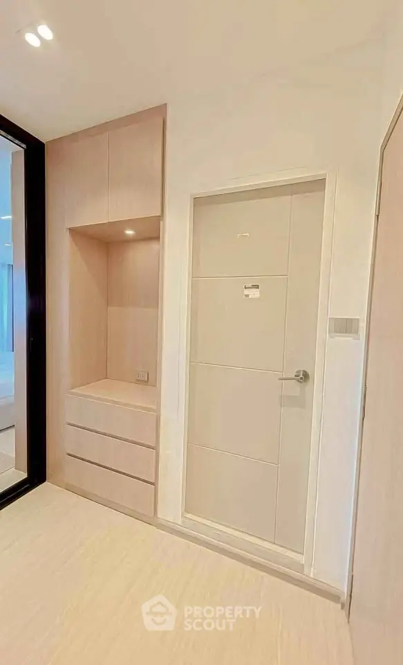 Modern minimalist interior with built-in storage and sleek door design.