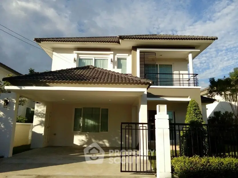 Modern two-story house with tiled roof and gated driveway