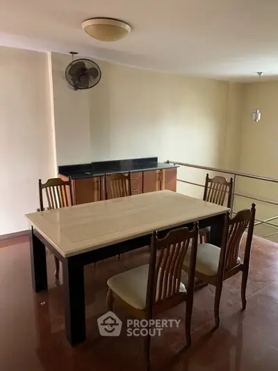 Spacious dining area with elegant wooden furniture and ample natural light