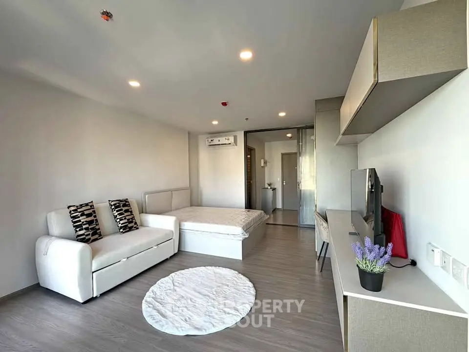Modern studio apartment with sleek design, featuring a cozy living area and stylish decor.