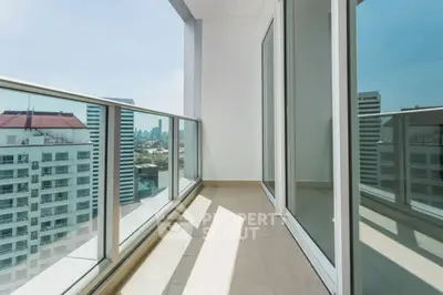 Spacious balcony with city skyline view in modern high-rise apartment.